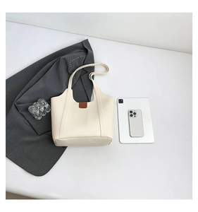 Top view of cream-white faux leather tote bag with brown accents and large capacity