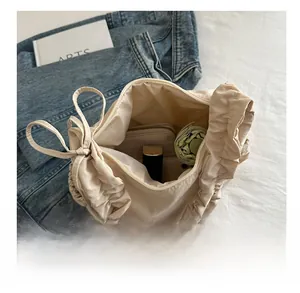 Top view of spacious nylon cloud bag interior showing phone, wallet and cosmetics