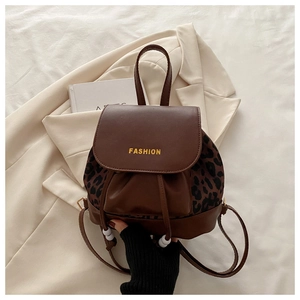 Detail of vintage leopard print backpack featuring drawstring closure and fashion lettering