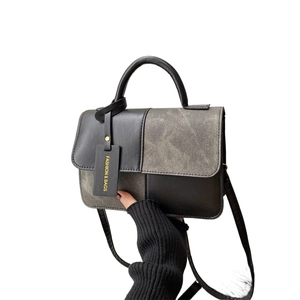 Fashionable black and grey patchwork tote bag with top handle and shoulder strap