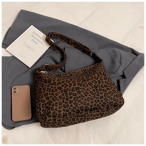 Leopard print canvas tote bag with zipper closure shown with books for size scale