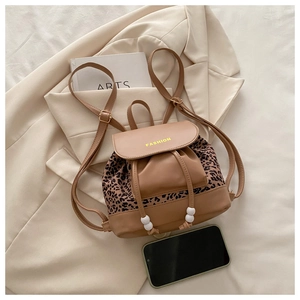 Detail of leopard print mini backpack with drawstring closure and fashion text