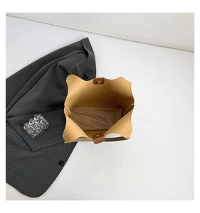Top view of spacious interior of tan tote bag with magnetic clasp and zipper pouch