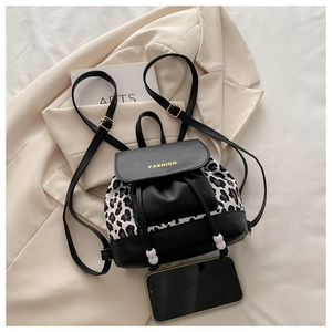 Detail view of mini leopard print backpack with contrast drawstrings and bead accents