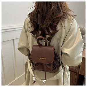 Detail view of the mini leopard print backpack with gold fashion lettering and drawstrings