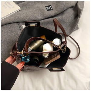 Spacious interior of brown crocodile embossed leather tote bag showing items