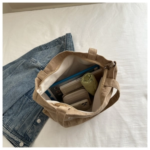 Detailed interior of a brown corduroy tote bag showing large capacity for daily items
