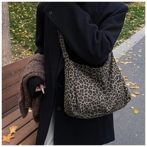 Large leopard print hobo shoulder bag styled on a park bench for casual autumn fashion