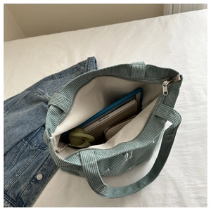 Top view of corduroy tote bag showing large interior space with zipper and lining