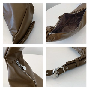 Detail view of brown PU leather shoulder bag with silver buckle and interior lining