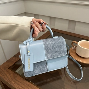 Chic light blue patchwork handbag with glitter details and adjustable shoulder strap