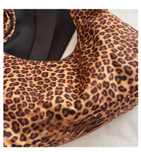 Macro detail of leopard print canvas tote bag featuring premium fuzzy suede texture