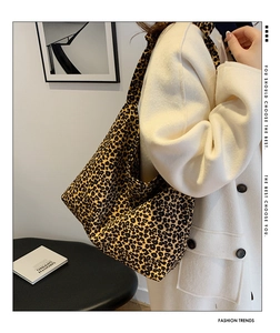 Leopard print tote bag styled with a white wool coat showing large capacity and texture