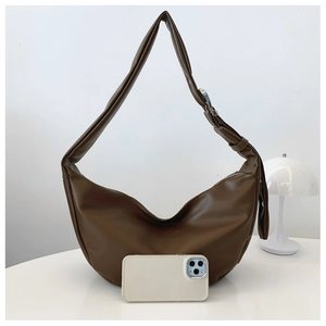 Close-up of brown crescent moon bag showing premium PU leather and silver buckle strap