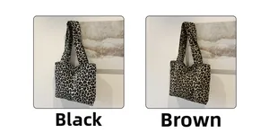 Detail view of large leopard print tote bags in black and brown canvas fabric