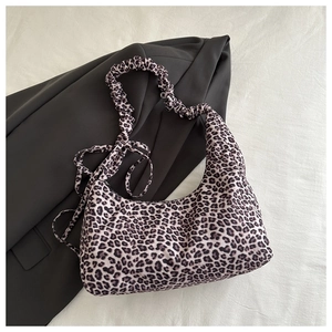 Close-up of leopard print hobo bag with ruched shoulder strap and ribbon bow detail