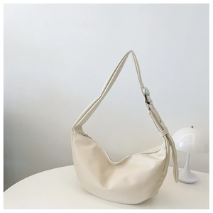 Minimalist beige half-moon crossbody bag with adjustable strap and smooth matte finish