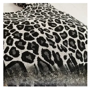 Macro shot of black and white leopard print woven fabric texture on fashion tote bag