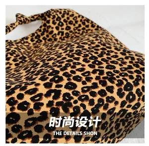 Detailed close-up of leopard print fabric texture and knotted shoulder strap design