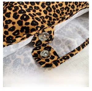Close-up of the magnetic clasp closure on the leopard print fabric shoulder bag