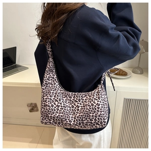 Close-up of leopard print hobo bag featuring a decorative side bow knot detail