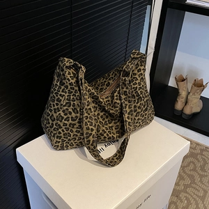 Large leopard print canvas tote bag with wide shoulder strap and zipper closure
