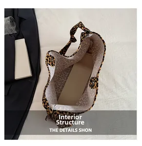 Detailed top view of a large leopard print canvas tote bag showing spacious interior structure