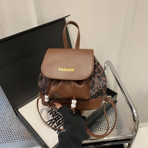 Retro leopard print backpack with brown leather accents and fashion drawstring closure