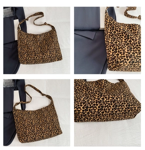 Detail view of leopard print tote bag showing strap stitching and canvas texture