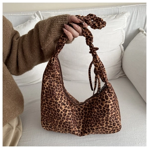 Detail of leopard print hobo bag featuring soft fabric and pleated cloud-like strap