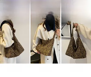 Detailed views of leopard print canvas tote bag showing shoulder and crossbody styling