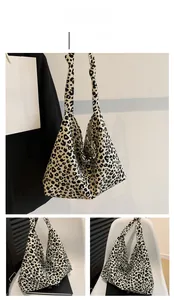 Detail view of large leopard print canvas tote bag with knotted shoulder strap design