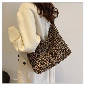 Side view of a vintage leopard print hobo bag worn by a model for a stylish look