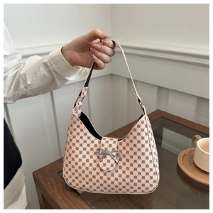 Pink hobo bag with dark circular patterns and a silver metal bow buckle detail