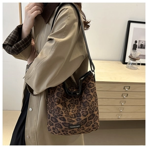 Close-up of leopard print hobo bag with Fashion & Bags label on textured fabric