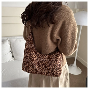 Leopard print hobo bag worn by model, showing the soft fabric texture and casual style