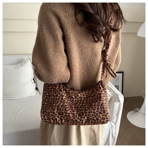 Detailed back view of a soft leopard print hobo bag with a knotted shoulder strap