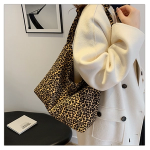 Close-up of leopard print tote bag fabric with casual draping on a minimalist background