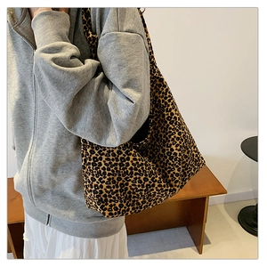 Leopard print canvas tote bag shown on model highlighting large capacity and stylish texture