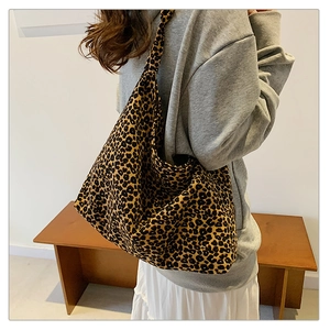 Rear view of a model wearing the large leopard print tote bag over the shoulder