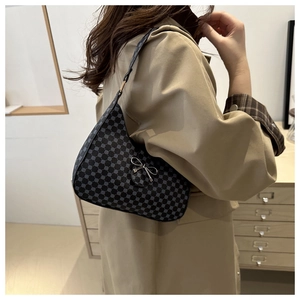 Chic crescent shoulder bag featuring a grey dotted pattern and a silver bow detail