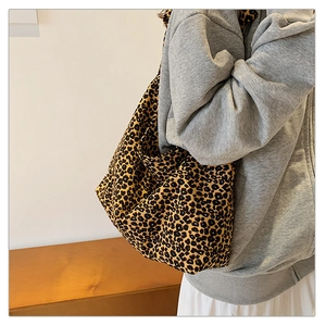Detailed view of leopard print canvas tote bag styled with a casual autumn outfit