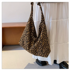 Detail of knot shoulder strap and large capacity leopard print canvas bag texture
