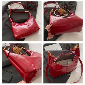 Detail view of red moon bag showing front, bottom, side, and interior lining compartments