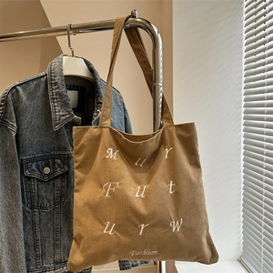 Corduroy tote bag with white embroidery letters and fashion text in khaki color