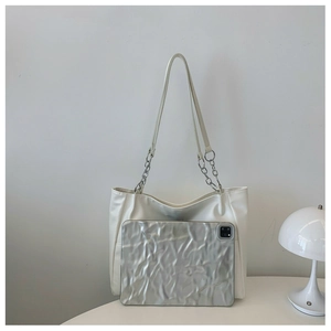 Detail showing white tote bag capacity with a tablet device inside to highlight spacious interior