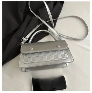 Detail of silver checkered crossbody bag showing metallic PU texture and dimensions