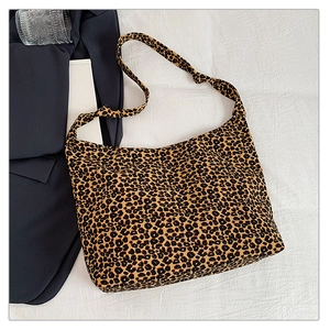 Detailed view of leopard print canvas hobo bag with a decorative knotted shoulder strap