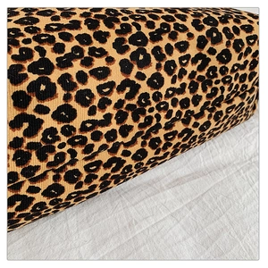 Close-up detail of high-quality leopard print jacquard fabric texture on a shoulder bag