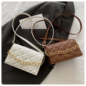 Close-up of quilted chain crossbody bags in cream and brown with gold metal link details